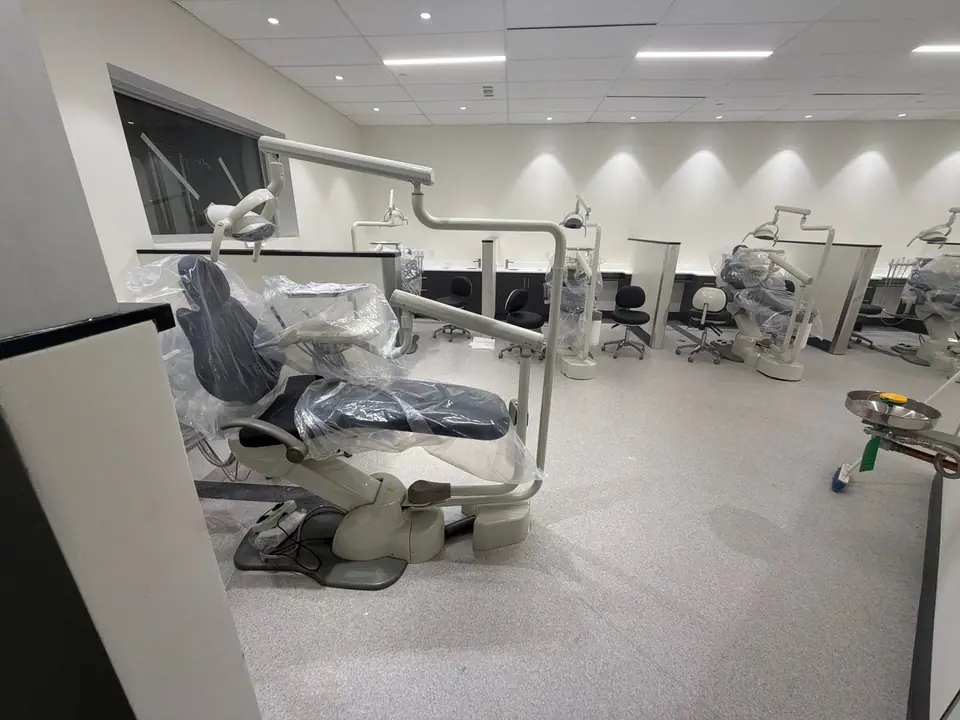 Dental clinic during construction, with new chairs still wrapped in protective plastic