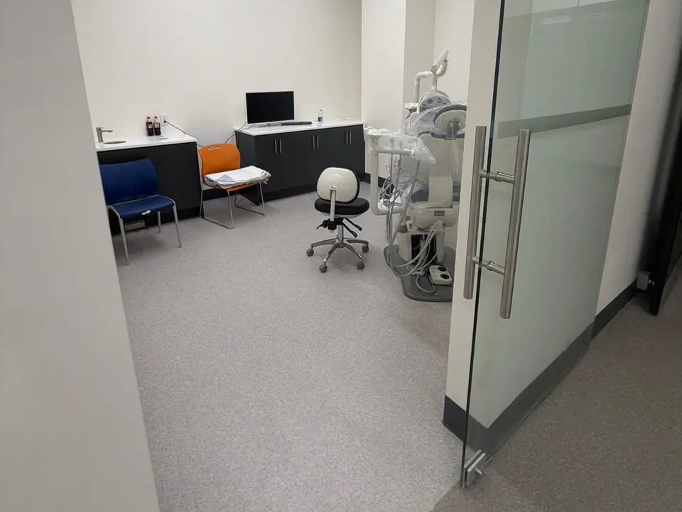 Private dental operatory with a glass door and clean floors