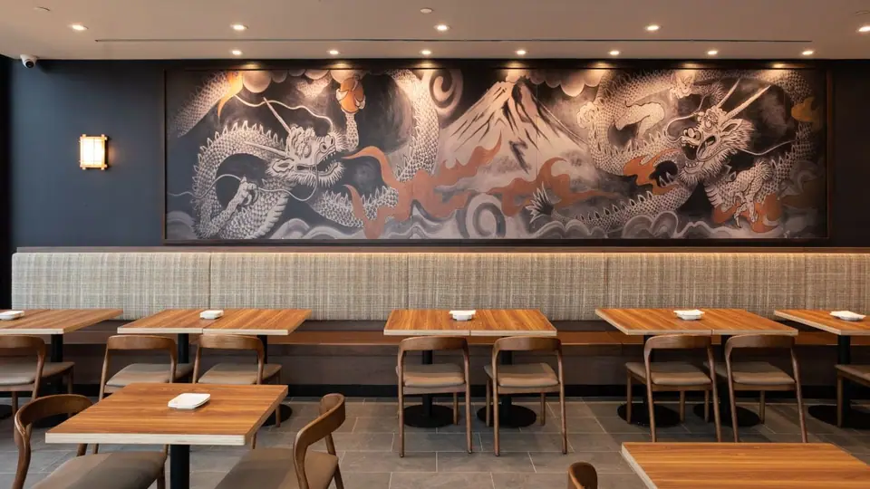 Restaurant dining room with a dragon mural after a turnover clean