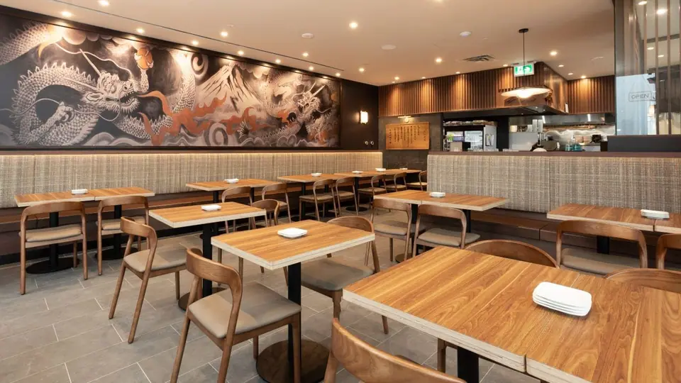 Restaurant dining room with banquette seating and wood tables