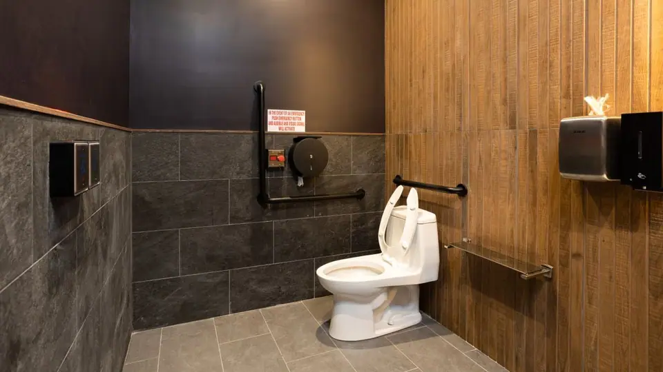 Restaurant washroom with tile walls and fixtures